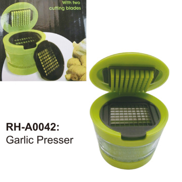 Garlic press with storage container