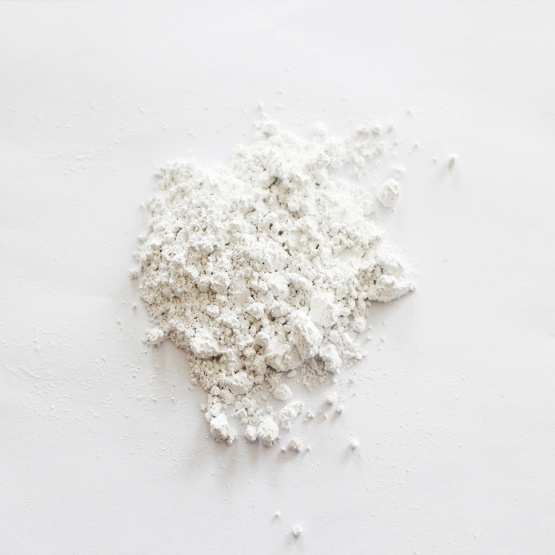 Non-corrosive calcium carbonate carrier additive