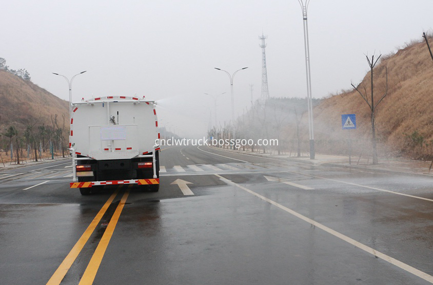 street water spray truck  in action 3