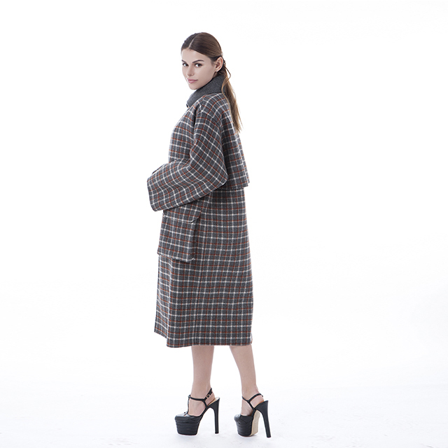 A turtleneck cashmere coat reveals a lady