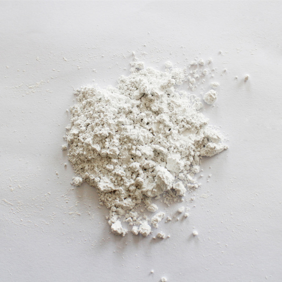 Non-corrosive calcium carbonate carrier additive
