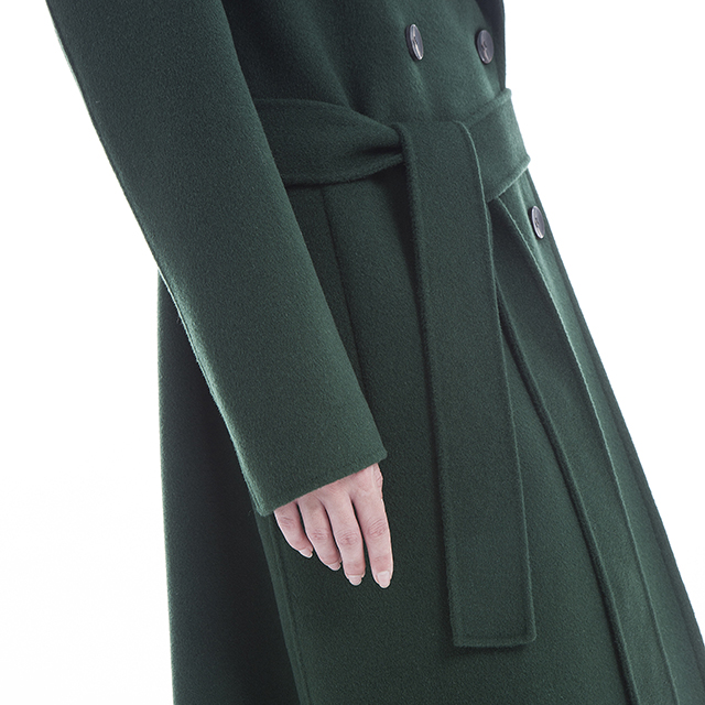 The lower half of a green cashmere overcoat