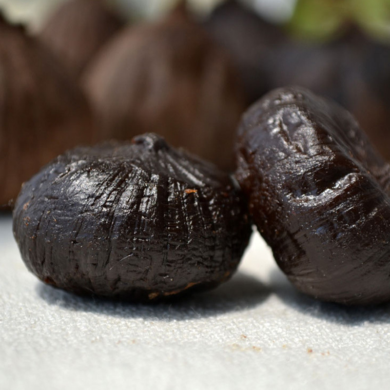 single peeled black garlic 