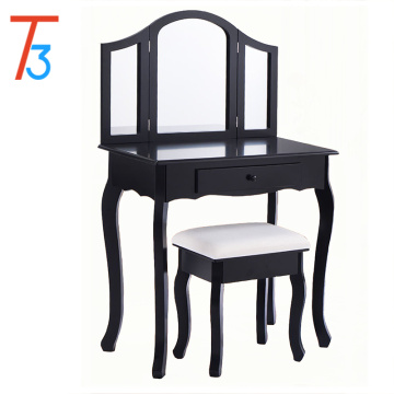 Bedroom with black dressing table with mirror and stool