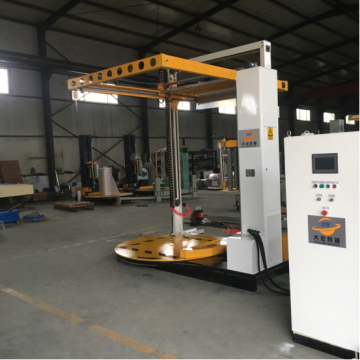 Pallet wrapping machine with top sheet cover