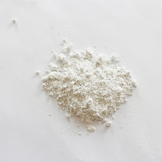 High whiteness calcium carbonate carrier additive