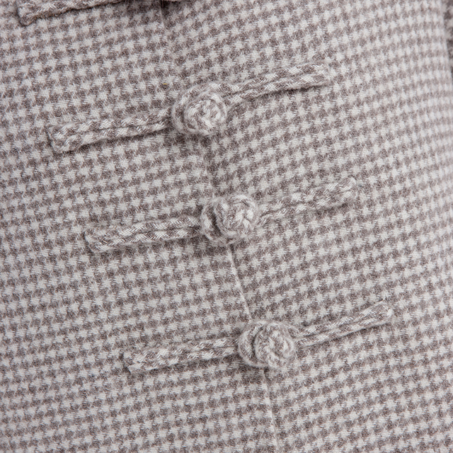 The button of a vintage cashmere overcoat with a standing collar