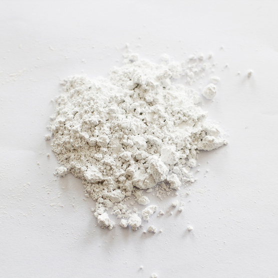 Non-corrosive calcium carbonate carrier additive