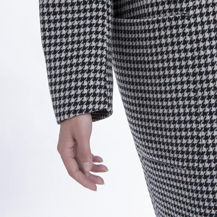 Sleeves of winter black and white checked cashmere overcoat