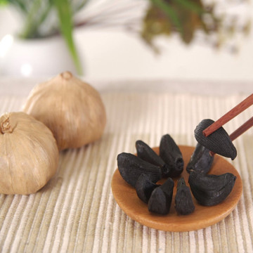 Uncracked whole black garlic with skin in jar