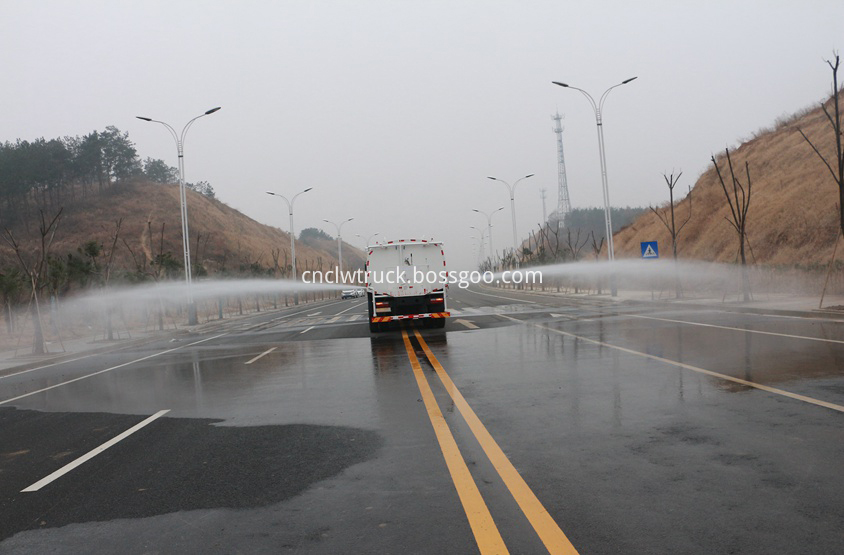 street water spray truck  in action 2